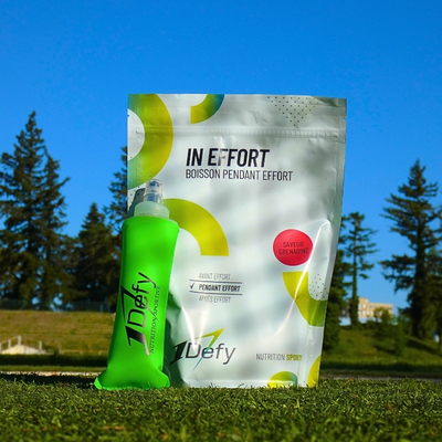 Sachet de boisson isotonique In Effort saveur grenadine avec une flasque souple entouré de verdure de la marque 1Defy Nutrition Sportive, made in bourgogne